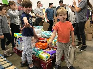 Bennett & Harry helping pack for boxes for Thanksgiving meals.